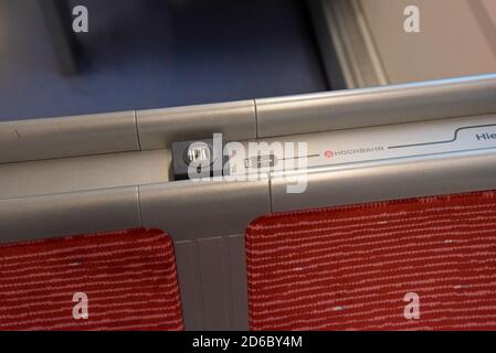 USB phone and device charging point on the seat back of a Hamburg Metro HVV train Stock Photo