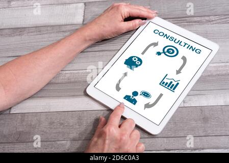 Consulting concept shown on a tablet used by a woman Stock Photo