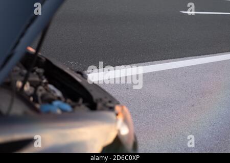 Car emergency or breakdown on highway road, waiting for help, car stopped during highway driving. Stock Photo