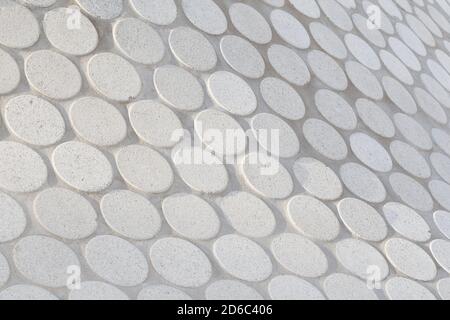Close-up of abstract geometric white stone slab pattern on a sunny day. Side view, focus on the front. High resolution full frame textured background. Stock Photo