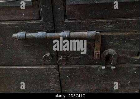 vintage latch on a historic door with signs of rust Stock Photo