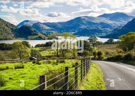 Barbed wire fence and view down to Ullswater from A5091 country road in Lake District National Park. Dockray, Cumbria, England, UK, Britain Stock Photo