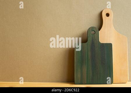 Wooden tray, cutting board, plate on wooden table with brown background Stock Photo