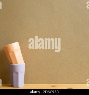 Stack of ceramic cups on wooden table with brown background Stock Photo