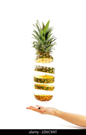 Pineapple fresh ananas. Pineapple sliced, levitates in the air. Concept of summer mood on white background, isolate. Tropical fruit. Stock Photo