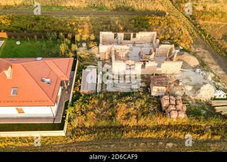 Top down aerial view of a house under construction with concrete foundament and brick walls. Stock Photo