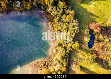 Autum Fall Top view from Drone of Lake Tegernsee and colorful Forest with trees. Lake Shore in bavaria. Beutiful Aerial Photography Stock Photo