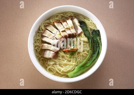 Asian style noodles soup with crispy roasted pork belly Stock Photo