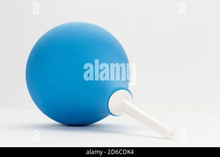 Blue enema ot syringe bulb on white background. Stock Photo