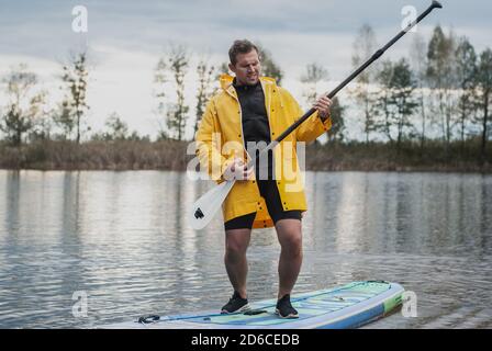 Man having fun with a paddle on an inflatable Board, Stock Photo
