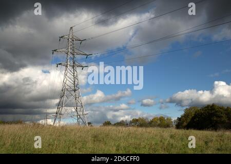 Electricity pylons in a rural setting with a blue sky Stock Photo - Alamy
