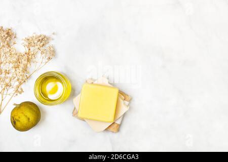 Yellow soap bars on a marble table in a top view Stock Photo