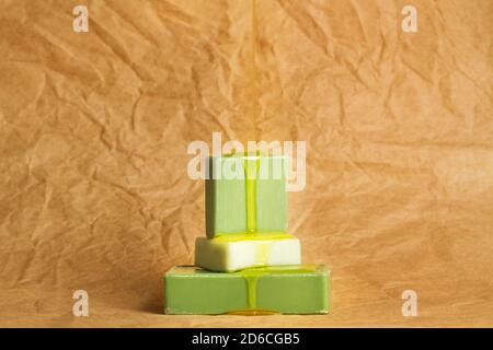 Dropping skin oil on green soap bars on a wrinkled brown paper Stock Photo