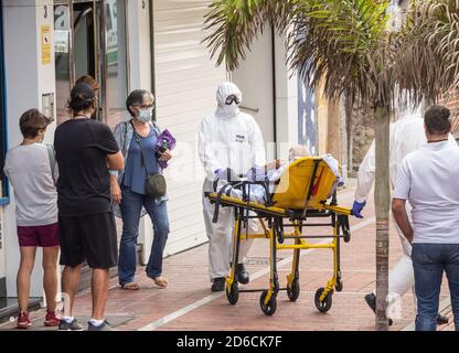 Ambulance crew in full Covid 19, Coronavirus protective clothing picking up patient on Gran Canaria, Canary Islands, Spain Stock Photo