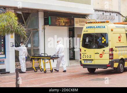 Ambulance crew in full Covid 19, Coronavirus protective clothing picking up patient on Gran Canaria, Canary Islands, Spain Stock Photo