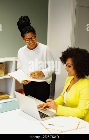Women using laptop in office Stock Photo