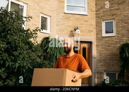 Man carrying cardboard box Stock Photo