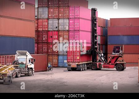 Mobile container handlers were operated at the cargo terminal in the port. Stock Photo