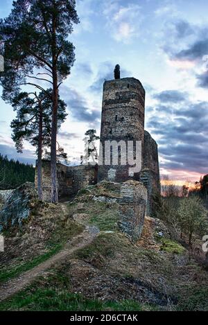 Beautiful medieval Czech castle Gutstejn located on the rock above the river in the Western Bohemia, shot at sunset. HDR Stock Photo