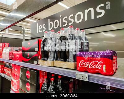 Puilboreau, France - October 14, 2020:Row of Coca cola soft drink bottle's and boxes display for sell in the supermarket shelves Stock Photo