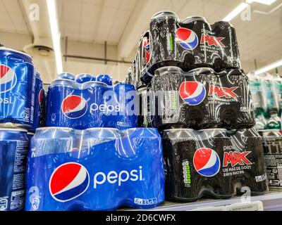 Puilboreau, France - October 14, 2020:PEPSI soft drink Original and max cans display on the supermarket shelf with selective focus. Pepsi is a carbona Stock Photo