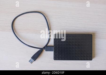 Top view shot of external hard drive for backup on wooden table Stock Photo