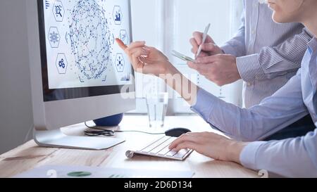 Data analysts working on data analytics and visualization with machine learning on computer screen in modern office. Data science in business, finance Stock Photo