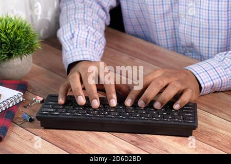 Close up of man hand typing on keyboard  Stock Photo