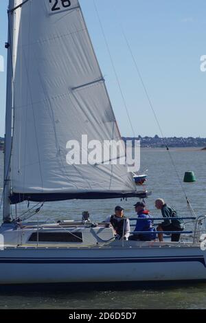 Yacht Sailing on the Exe Estuary by Turf Lock on a sunny autumn day. Devon, UK. Stock Photo