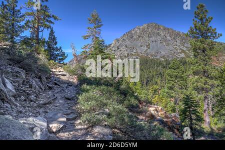 SOUTH LAKE TAHOE, CALIFORNIA, UNITED STATES - Oct 14, 2020: A hiking trail ascends from the South Lake Tahoe community of Fallen Leaf Lake with Mt Tal Stock Photo