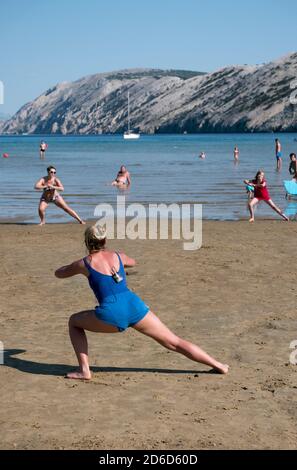 24.06.2020, San Marino, Rab, Primorje-Gorski kotar, Croatia - Aerobic exercise for tourists at Paradise Beach. 00A200624D044CAROEX.JPG [MODEL RELEASE: Stock Photo