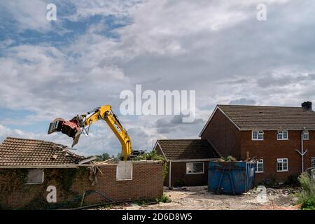 Heavy machinery demolishes private house to make way for development of new Lidl supermarket along Minster Way in Beverley, Yorkshire, UK. Stock Photo