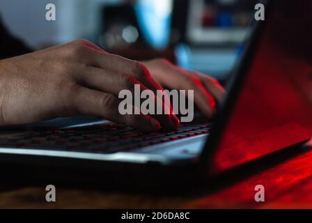 a man working in a laptop close-up, hands on the keyboard, Stock Photo