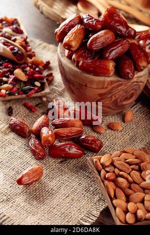 Dates and dried fruits on a old wooden table. Selective focus. Stock Photo