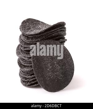 Stack of of black potato chips isolated on white Stock Photo
