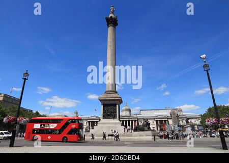 LONDON, UK - JULY 6, 2016: People ride New Routemaster bus at Trafalgar Square, London. The hybrid diesel-electric bus is a new, modern version of ico Stock Photo