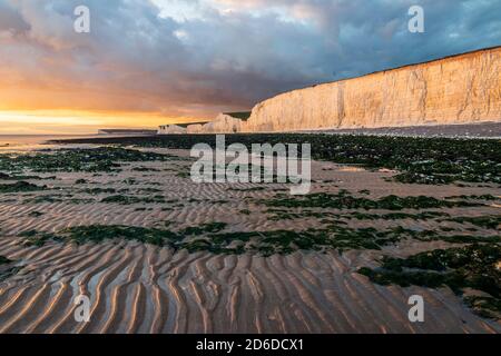 Sunset and low tide at Birling Gap at the foot of the seven sisters cliffs in east Sussex south east England Stock Photo