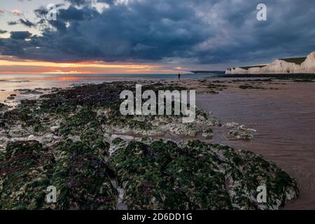 Dramatic red dawn mackerel sky over the beachfront of Hastings in east Sussex south east England Stock Photo