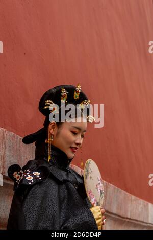 Beijing, China - November 21 2019: A young Chinese model dressed in black poses inside the Forbidden City in Beijing, November 21 2019, Beijing China Stock Photo