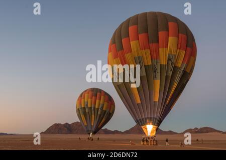 A hot air balloon ride in Namibia. Two hot air balloons shortly before the start. Stock Photo