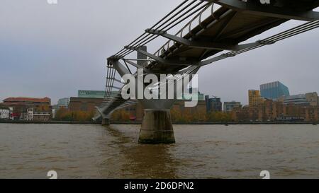 London, UK - 11/23/2018: View from below of suspension bridge Millennium Bridge (London Millennium Footbridge), spanning Thames River. Stock Photo