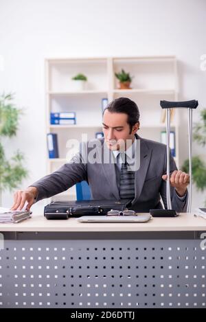 Young employee after accident at workplace Stock Photo