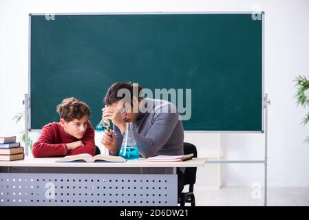 Young teacher and schoolboy in the classroom Stock Photo