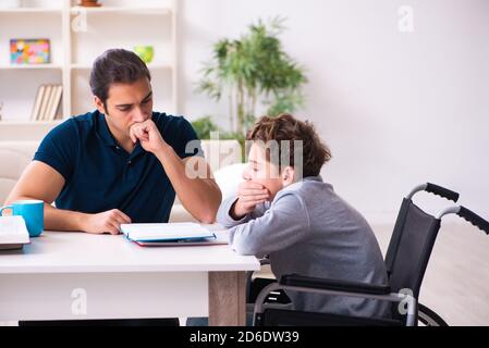 Father and disabled son in the education concept Stock Photo