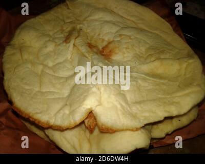 Naan Bread Close up Photo Capture. Tandoori Naan. Bangladeshi and Indian Naan Roti. Naan is a leavened, oven-baked flatbread found in the cuisines mai Stock Photo