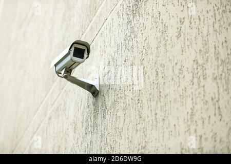 Surveillance camera on a building wall. Stock Photo