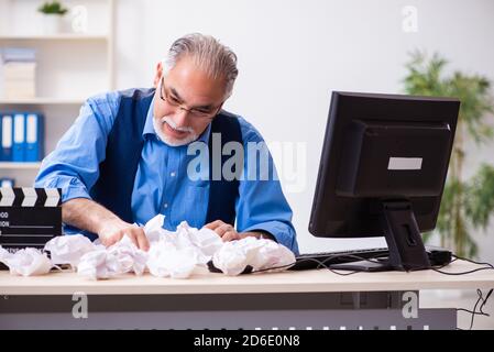 Old male author writing the screenplay Stock Photo