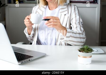 Woman working on her laptop with blank copy space screen. Mock up laptop with womans hands.Back view of business women hands using laptop.Home office Stock Photo