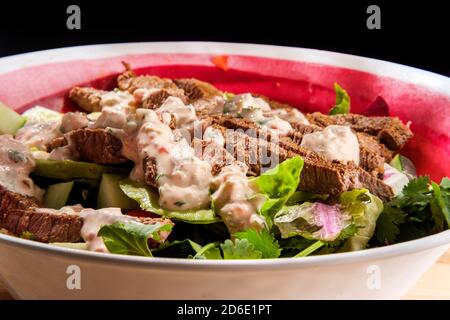 Large Mexican steak salad bowl with romaine lettuce and creamy chipotle pepper dressing Stock Photo