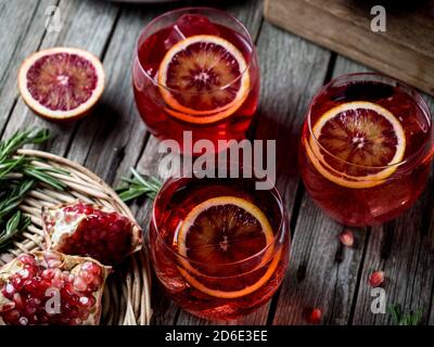 Blood orange and pomegranate cocktails on a grunge wooden table Stock Photo